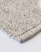 Nebraska Floor Rug in Pebble, close-up of a corner showing the edge and wool and viscose pile