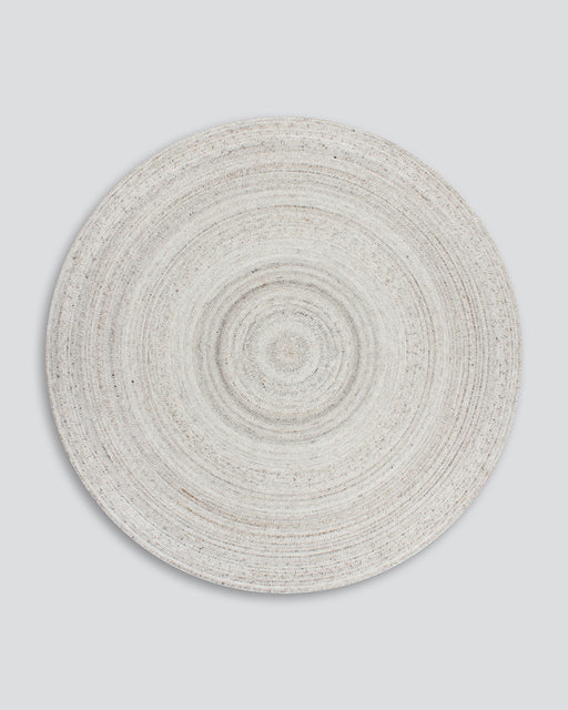 Palm Cove Round Floor Rug in Sand, the whole round rug shown flat on a plain background