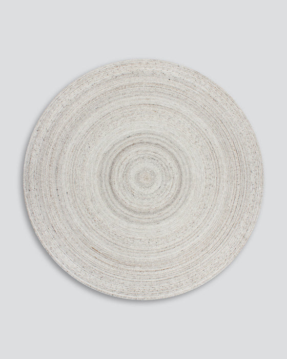 Palm Cove Round Floor Rug in Sand, the whole round rug shown flat on a plain background