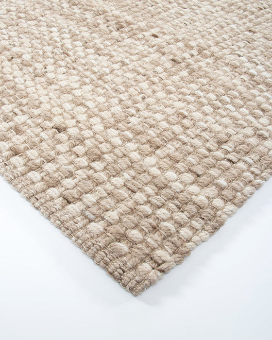 Pelorus Floor Rug in Sand, close-up of a corner showing the edge and recycled PET pile
