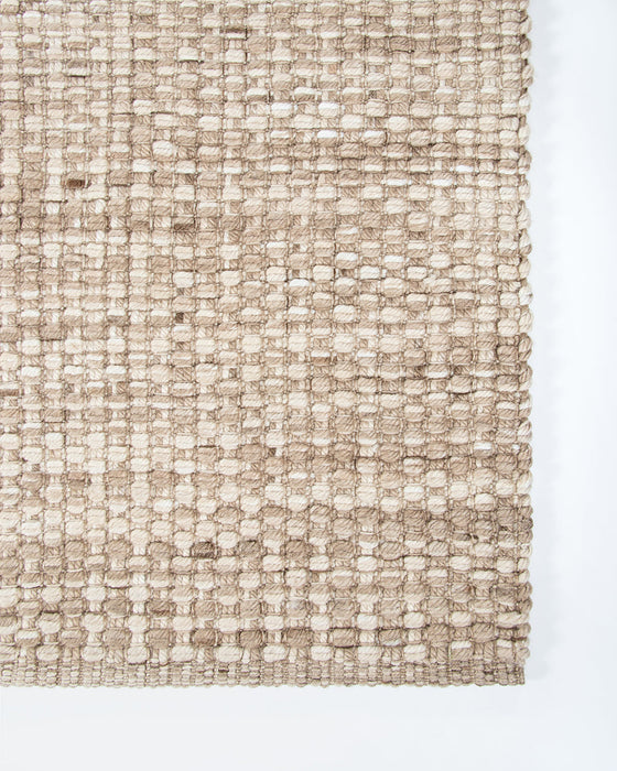 Pelorus Floor Rug in Sand, close-up of a corner showing the edge and recycled PET pile