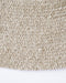 Tairua Round Floor Rug in Natural Straw, close-up of the curved edge and wool and viscose weave
