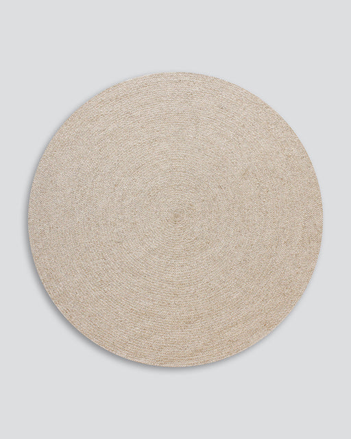 Tairua Round Floor Rug in Natural Straw, the whole round rug shown flat on a plain background