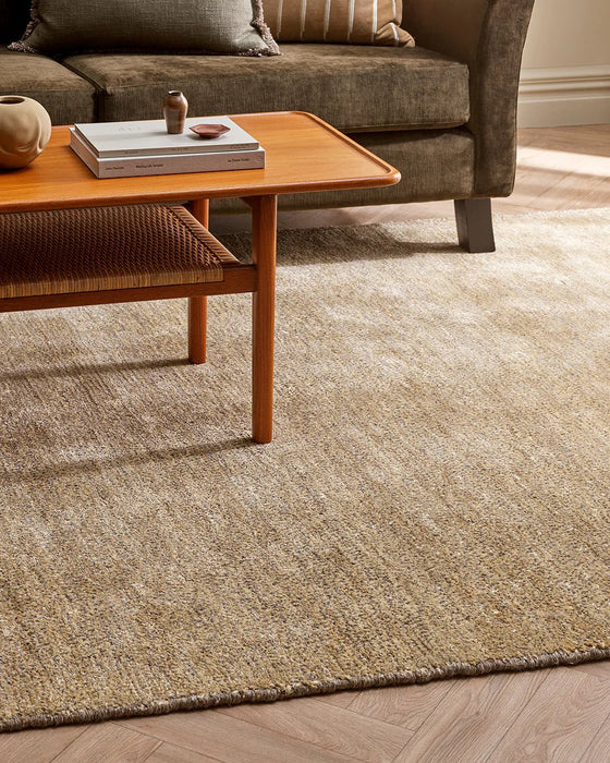 Fairbanks Floor Rug in Limestone, under a timber coffee table beside an olive velvet sofa