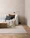 Vermont Floor Rug in Driftwood, in a living room with a white sofa, cushions and stone coffee table