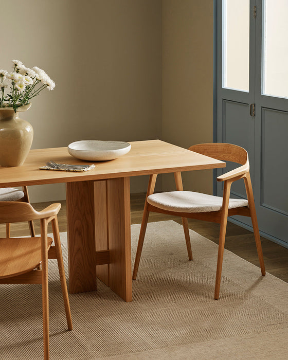Vermont Floor Rug in Sand, under a timber dining table with timber and white seat chairs