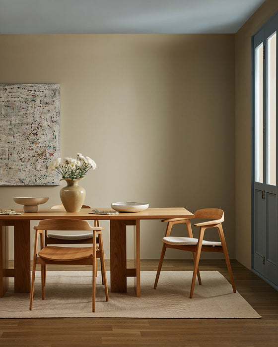 Vermont Floor Rug in Sand, under a timber dining table with matching chairs in a beige room