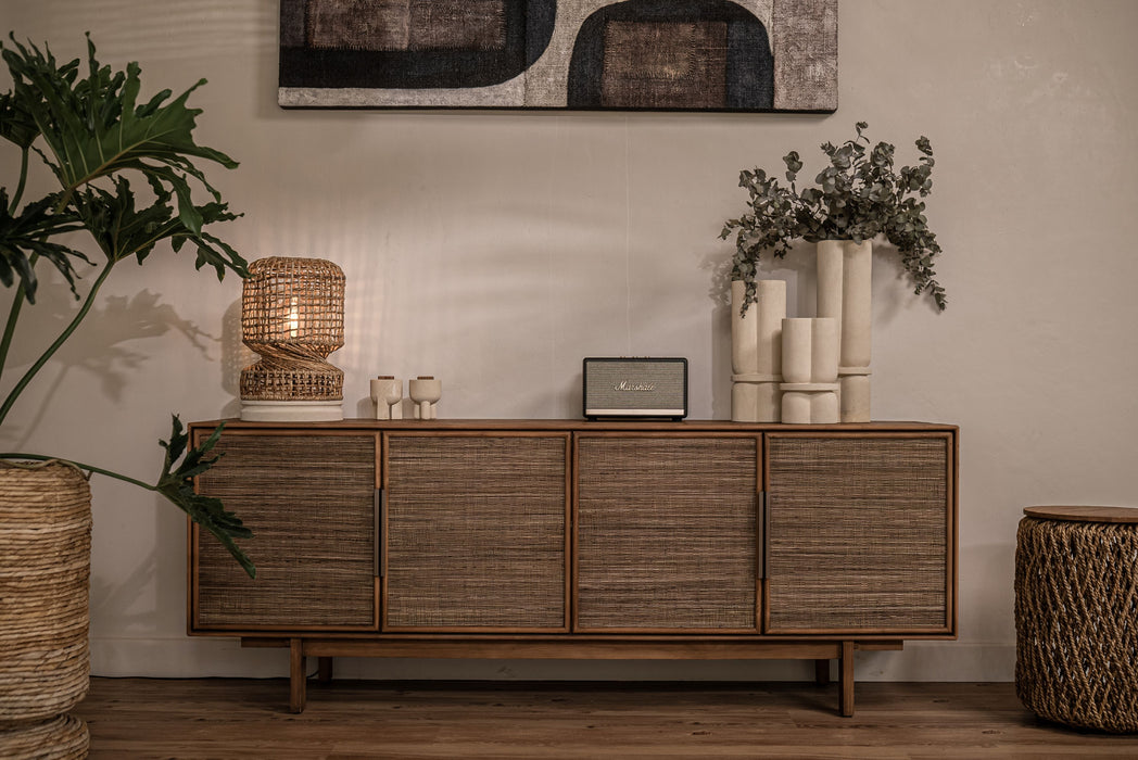 dBodhi Grace Dresser styled with a woven table lamp, white vases and plants against a pale wall