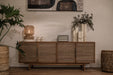 dBodhi Grace Dresser styled with a woven table lamp, white vases and plants against a pale wall